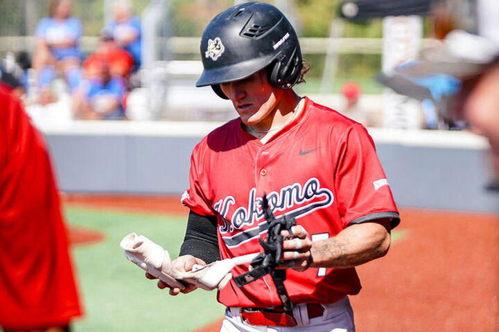 An IU Kokomo catcher walks back from the pitching mound.